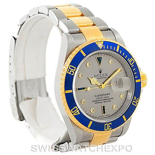 The image shows a side-front angle of a Rolex Submariner 16613 Men's Steel and Gold (two tone) Grey Dial 16613 Men's Steel and Gold (two tone) Grey Dial watch, highlighting its bezel, dial, crown, and two-tone bracelet.