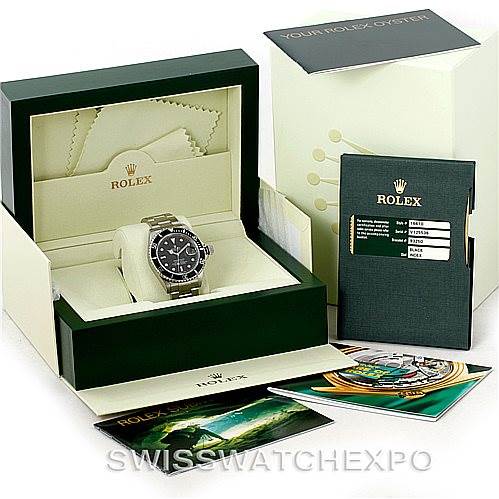 The image shows a Rolex Submariner 16610 Men
s Stainless Steel Black Dial 16610 Men
s Stainless Steel Black Dial watch at a front angle, displayed in its open box with accompanying booklets and warranty card.