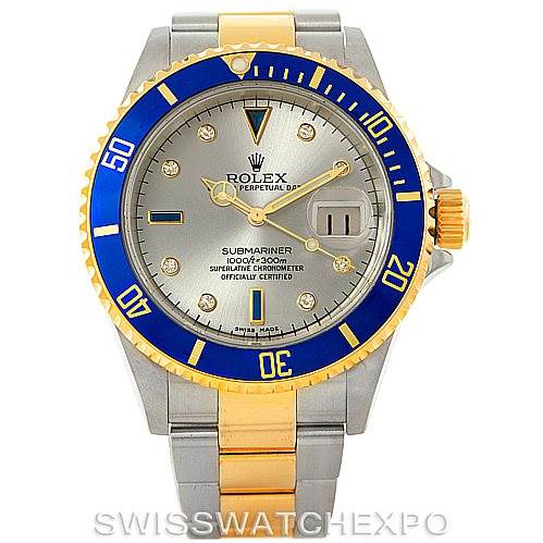 The Rolex Submariner 16613 Men
s Steel and Gold (two tone) Grey Dial 16613 Men
s Steel and Gold (two tone) Grey Dial watch is shown from a front angle, featuring a blue bezel, gold and silver band, and detailed face.