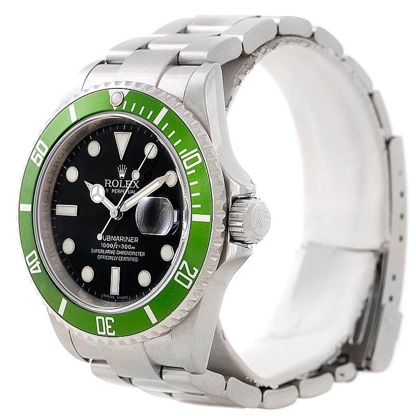The image shows a Rolex Submariner 16610V Men
s Stainless Steel Black Dial 16610V Men
s Stainless Steel Black Dial watch from a side angle, highlighting its green bezel, black dial, and steel bracelet.