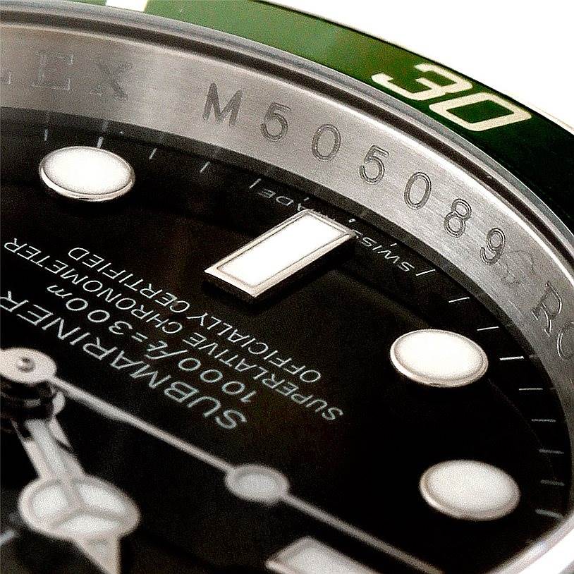 This close-up image shows the dial, indices, and part of the bezel of a Rolex Submariner 16610V Men
s Stainless Steel Black Dial 16610V Men
s Stainless Steel Black Dial watch.