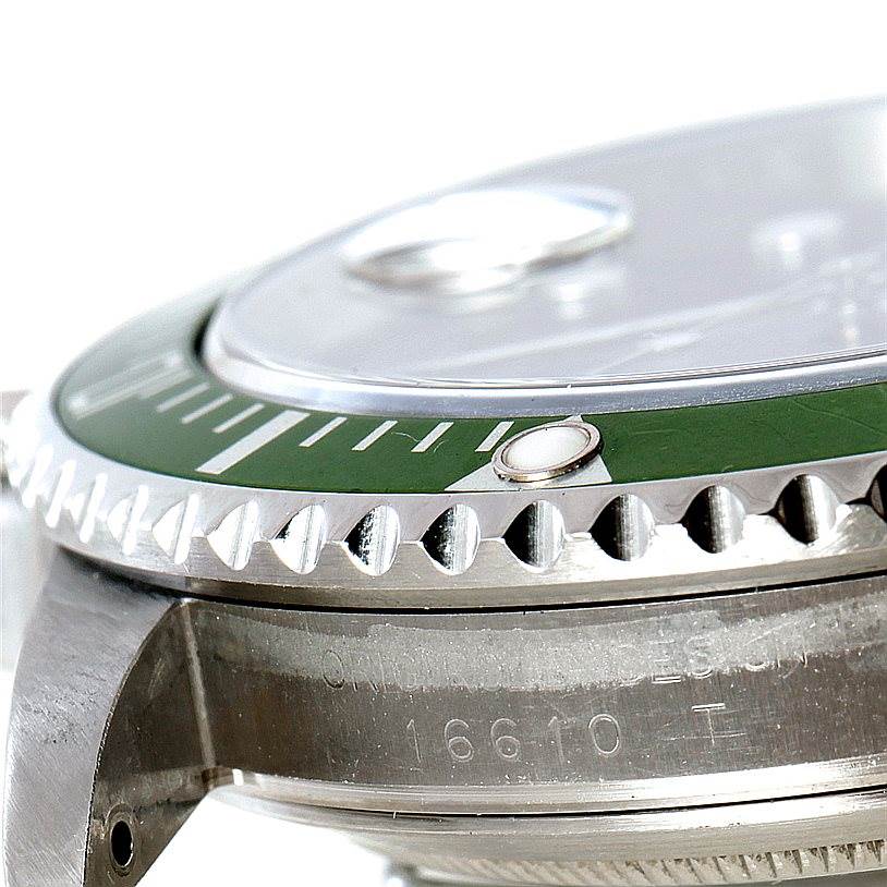 The image shows a close-up side view of the bezel and part of the case of the Rolex Submariner 16610V Men
s Stainless Steel Black Dial 16610V Men
s Stainless Steel Black Dial watch, model 16610.