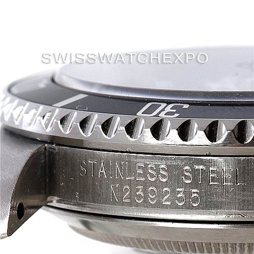 This close-up image of the Rolex Submariner 16610 Men
s Stainless Steel Black Dial 16610 Men
s Stainless Steel Black Dial watch shows the side profile, including the bezel with minute markers, and the engraved case with the model information.