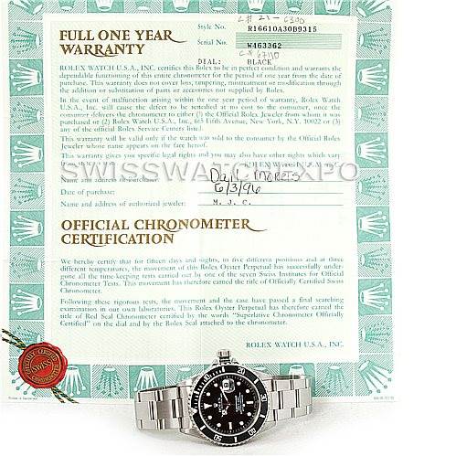 The image shows a Rolex Submariner 16610 Men
s Stainless Steel Black Dial 16610 Men
s Stainless Steel Black Dial watch laying flat, along with its warranty and certification documents.