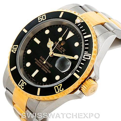 The image shows a Rolex Submariner 16613 Men's Steel and Gold (two tone) Black Dial 16613 Men's Steel and Gold (two tone) Black Dial watch angled to display its black dial, bezel, crown, and two-tone bracelet.
