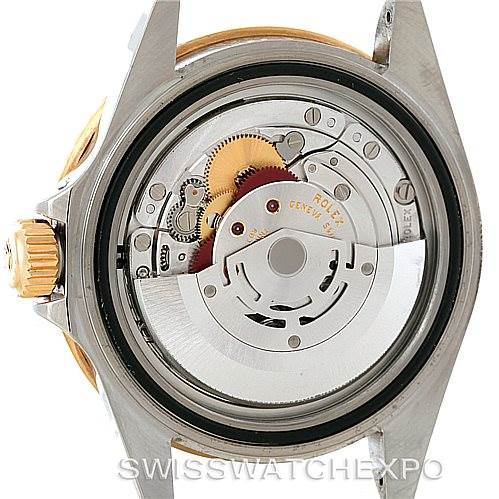 The image shows the rear view of the inner mechanism of a Rolex Submariner 16613 Men's Steel and Gold (two tone) Black Dial 16613 Men's Steel and Gold (two tone) Black Dial watch, highlighting its intricate gears and components.