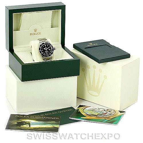The image shows a Rolex Submariner 16610 Men
s Stainless Steel Black Dial 16610 Men
s Stainless Steel Black Dial watch in its box, along with its outer box, manuals, and warranty card holder.