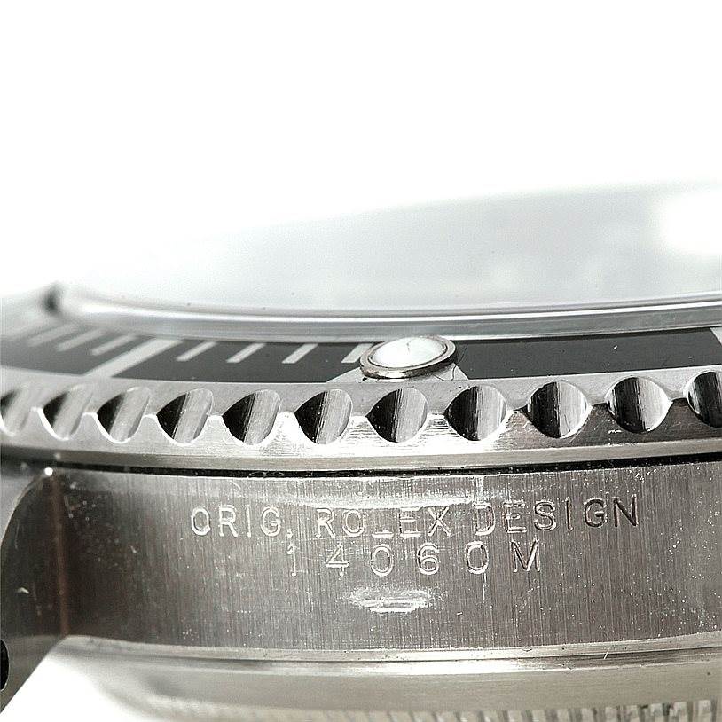 This close-up image of the Rolex Submariner 14060 Men
s Stainless Steel Black Dial 14060 Men
s Stainless Steel Black Dial shows the bezel and the engraved side of the case.