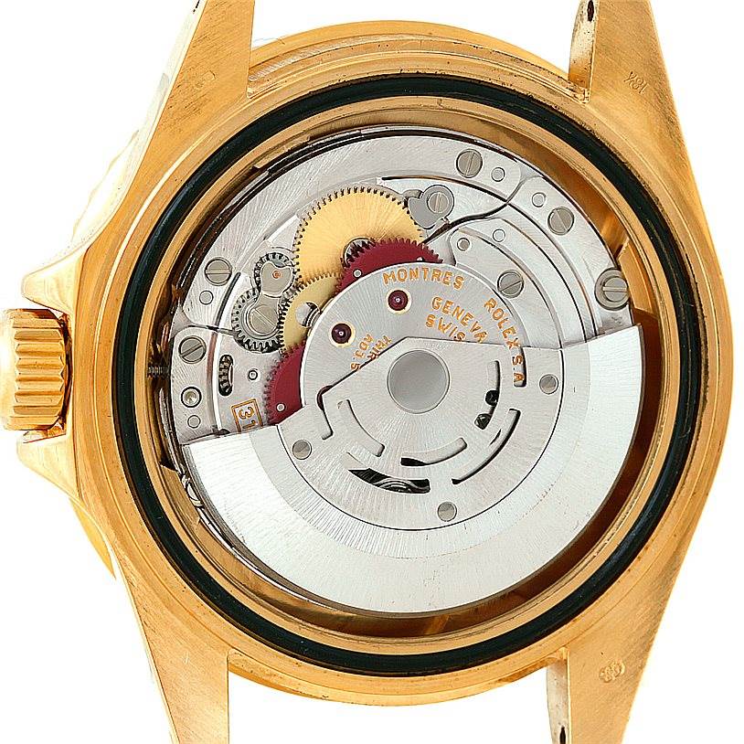 An open-back view of a Rolex Submariner 16618 Men's Yellow Gold Grey Dial 16618 Men's Yellow Gold Grey Dial watch displaying the intricate mechanics and gears inside the case.