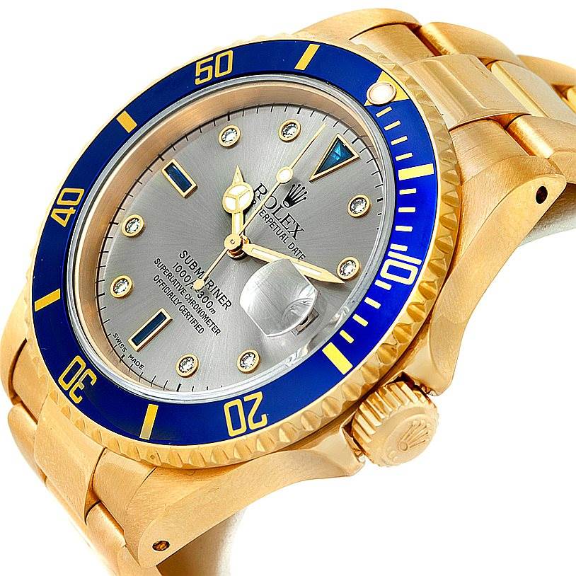 This image shows a gold Rolex Submariner 16618 Men's Yellow Gold Grey Dial 16618 Men's Yellow Gold Grey Dial watch at an angled view, highlighting the face, bezel, crown, and part of the bracelet.