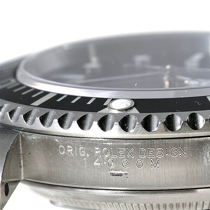 This close-up image shows the side of the bezel and case of a Rolex Submariner 14060 Men
s Stainless Steel Black Dial 14060 Men
s Stainless Steel Black Dial watch, with the model number engraved.