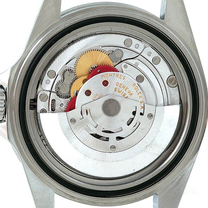 The image shows a close-up of the Rolex Submariner 14060 Men
s Stainless Steel Black Dial 14060 Men
s Stainless Steel Black Dial’s open case back, revealing its internal mechanical movement.