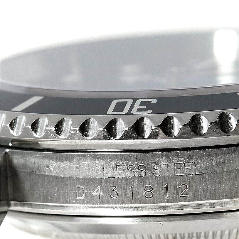 This image shows a close-up of the case, bezel, and part of the serial number of a Rolex Submariner 16610 Men
s Stainless Steel Black Dial 16610 Men
s Stainless Steel Black Dial watch.