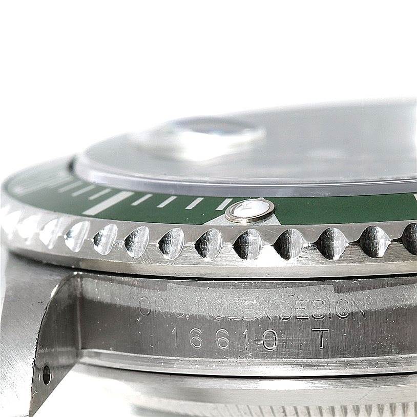 This close-up shot of the Rolex Submariner 16610 Men
s Stainless Steel Black Dial 16610 Men
s Stainless Steel Black Dial shows the bezel, part of the crystal, and model engraving on the case.