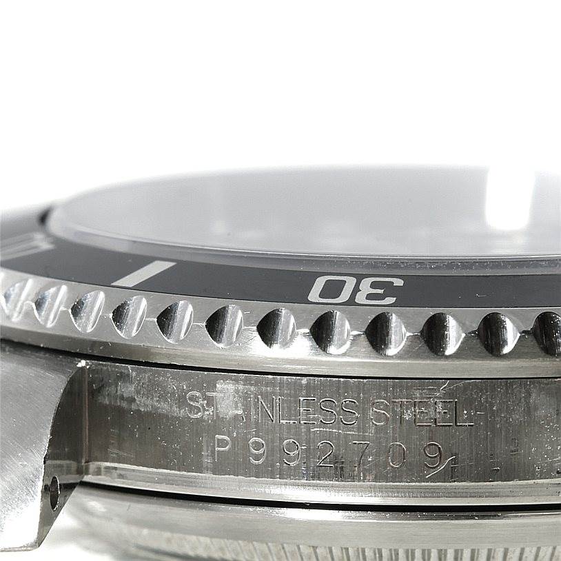 This image shows a close-up side view of the Rolex Submariner 16610 Men
s Stainless Steel Black Dial 16610 Men
s Stainless Steel Black Dial watch, highlighting the bezel, case, and part of the serial number.