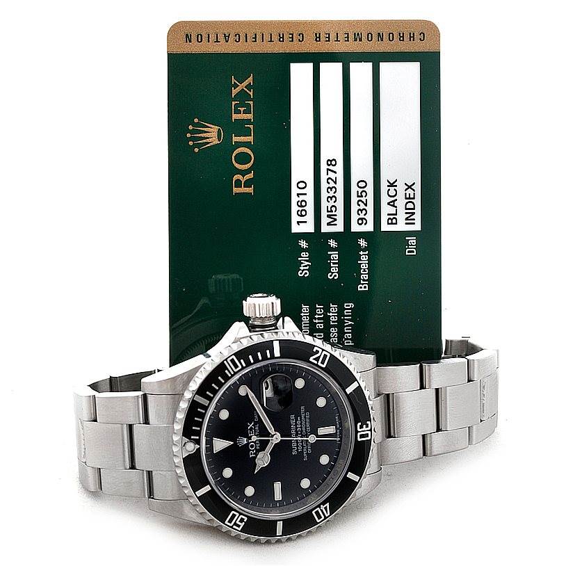 The image shows a Rolex Submariner 16610 Men
s Stainless Steel Black Dial 16610 Men
s Stainless Steel Black Dial watch resting on its side with a visible dial, bezel, bracelet, and certification card in the background.