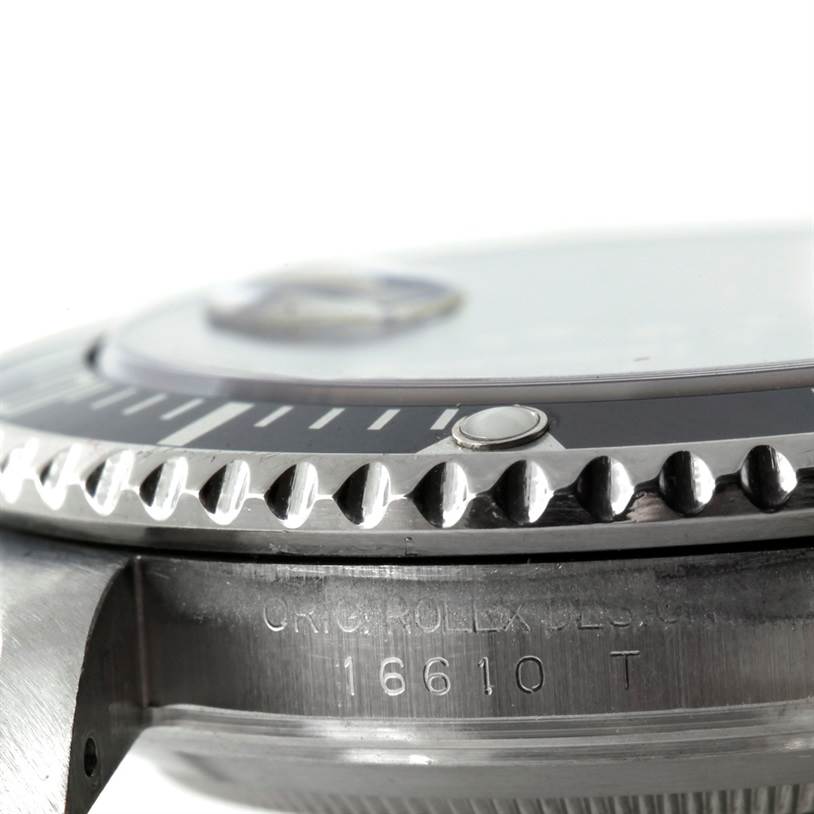 Close-up side view of a Rolex Submariner 16610 Men
s Stainless Steel Black Dial 16610 Men
s Stainless Steel Black Dial showing its bezel and part of the case with model number.