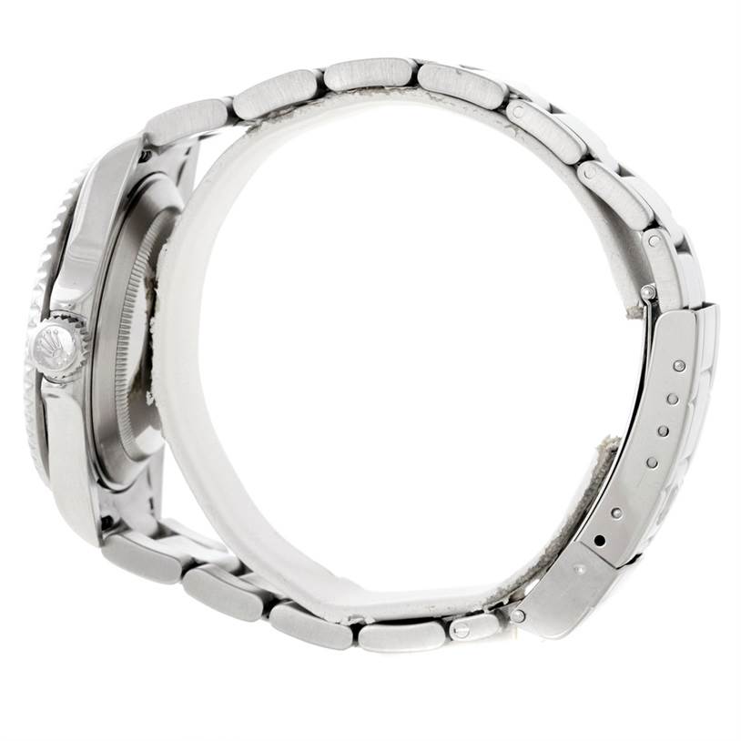 The image shows a side view of the Rolex Submariner 16610 Men
s Stainless Steel Black Dial 16610 Men
s Stainless Steel Black Dial, highlighting its case, crown, and metal bracelet with the clasp.