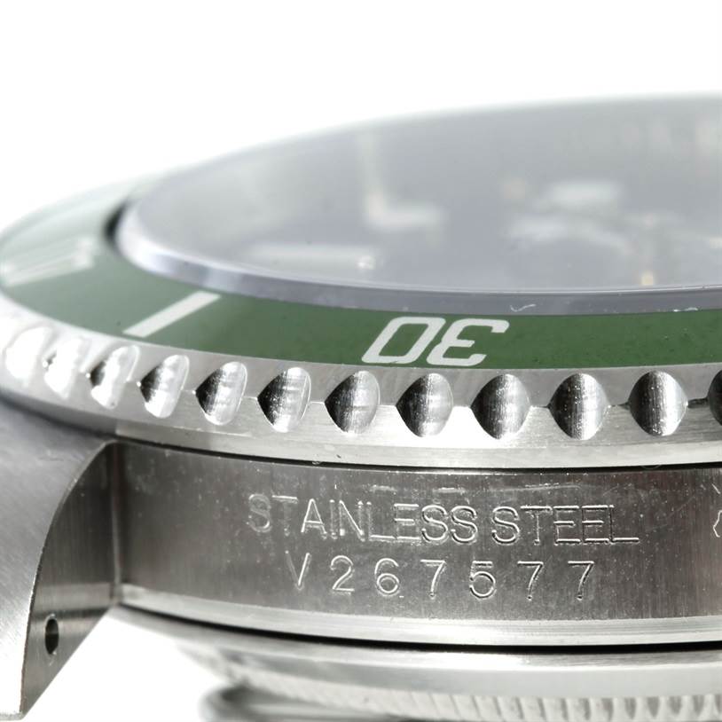 The image shows a close-up of the side and bezel of a Rolex Submariner 16610 Men
s Stainless Steel Black Dial 16610 Men
s Stainless Steel Black Dial watch, highlighting the stainless steel material and serial number.