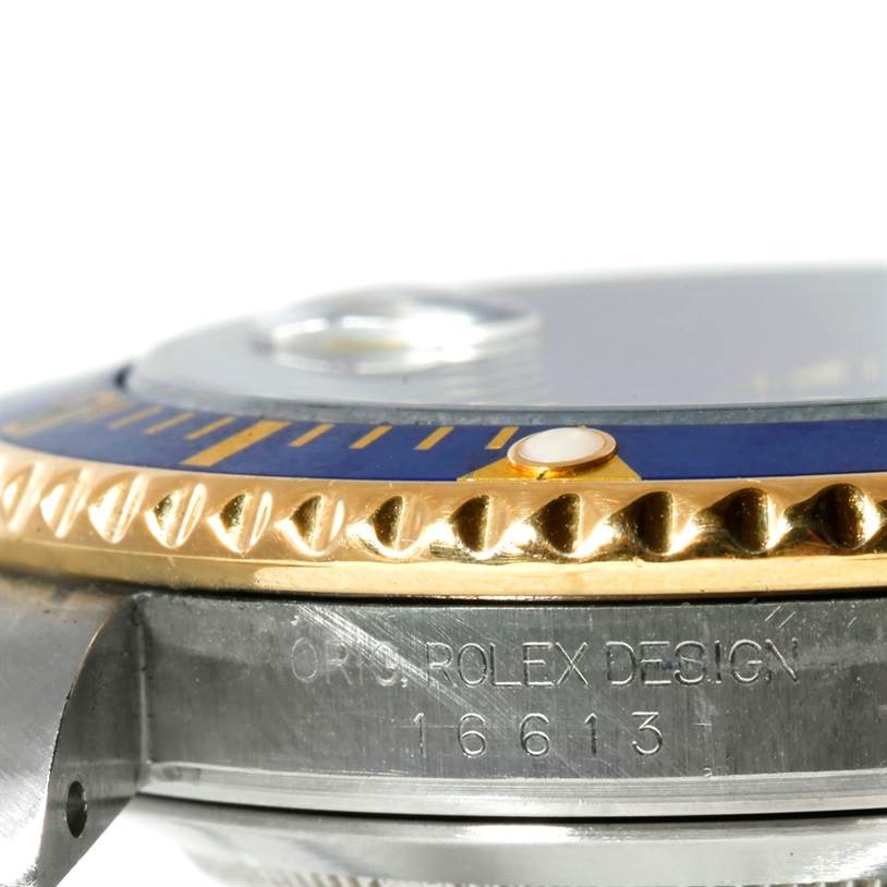 This close-up angle of the Rolex Submariner 16613 Men's Steel and Gold (two tone) Blue Dial 16613 Men's Steel and Gold (two tone) Blue Dial features the model number "16613" and part of the bezel, crystal, and case.