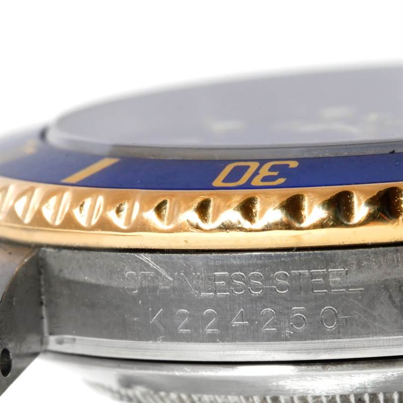 The image shows a close-up side view of a Rolex Submariner 16613 Men's Steel and Gold (two tone) Blue Dial 16613 Men's Steel and Gold (two tone) Blue Dial watch, highlighting the bezel with "30" marking and part of the stainless steel case with serial number.