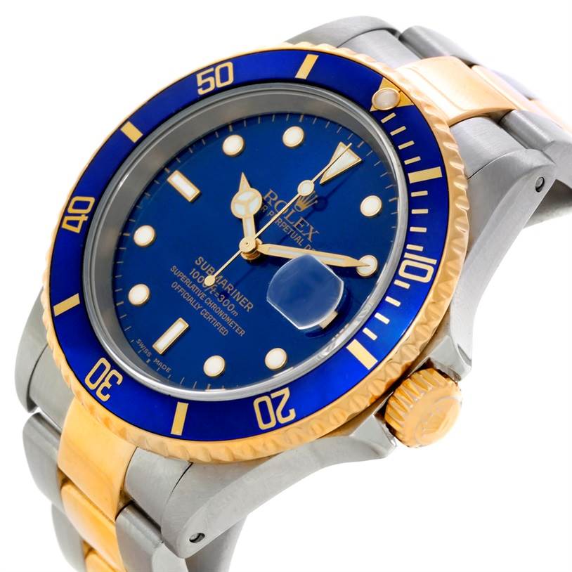 The image shows a close-up, angled view of a Rolex Submariner 16613 Men's Steel and Gold (two tone) Blue Dial 16613 Men's Steel and Gold (two tone) Blue Dial watch, highlighting the bezel, dial, crown, and part of the bracelet.