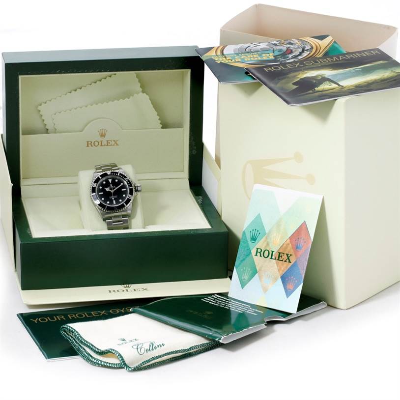 The image shows a Rolex Submariner 14060 Men
s Stainless Steel Black Dial 14060 Men
s Stainless Steel Black Dial watch in its open box along with accompanying manuals and cleaning cloths.
