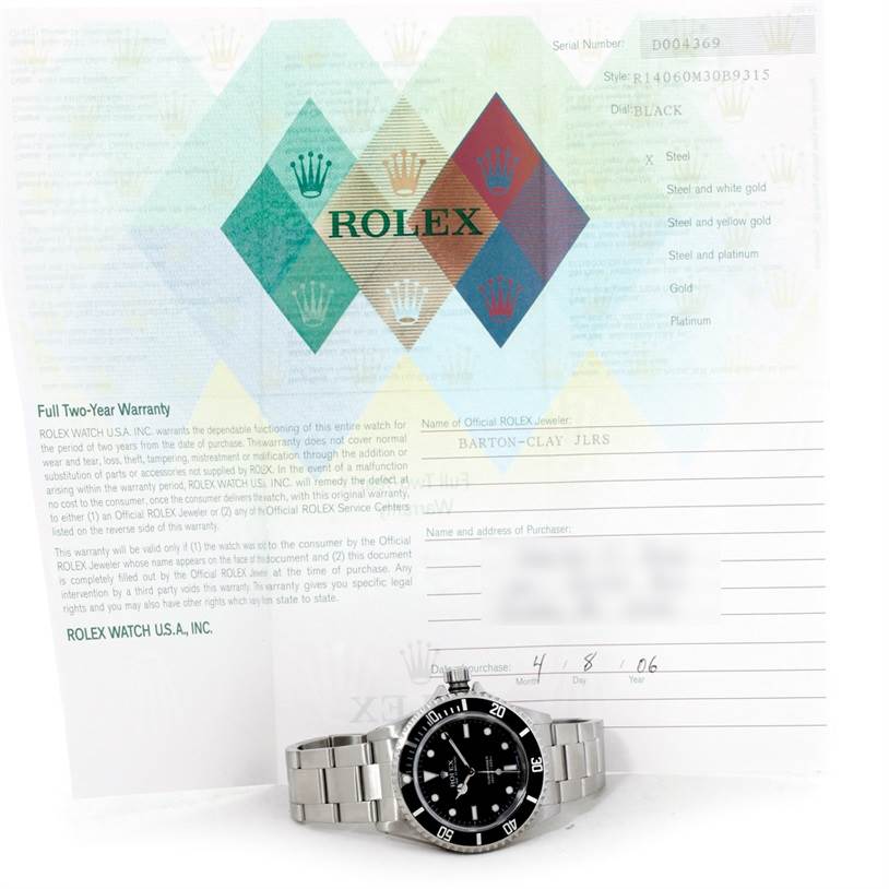 The image shows a Rolex Submariner 14060 Men
s Stainless Steel Black Dial 14060 Men
s Stainless Steel Black Dial watch positioned in front of its warranty and certificate paperwork.