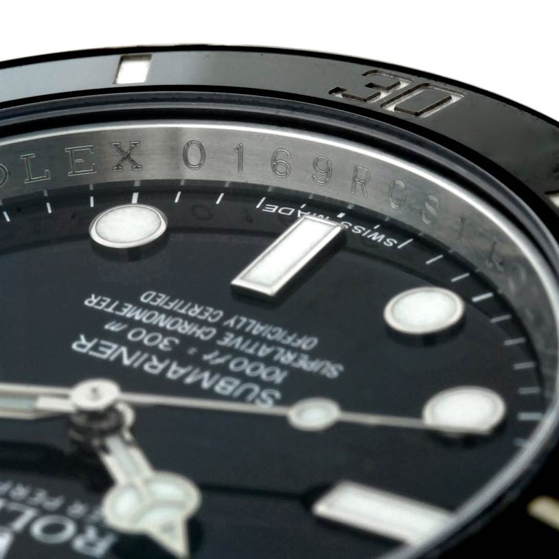 The image shows a close-up angle of the Rolex Submariner 114060 Men
s Stainless Steel Black Dial 114060 Men
s Stainless Steel Black Dial watch, focusing on the bezel, part of the dial, and the hour markers.