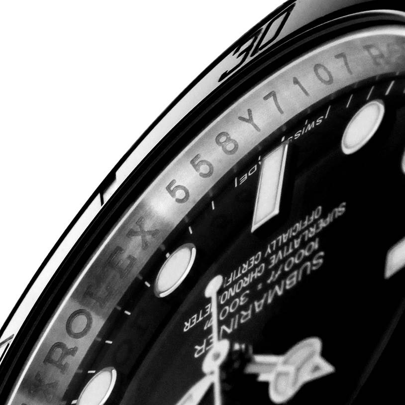 The image shows a close-up of the Rolex Submariner 114060 Men
s Stainless Steel Black Dial 114060 Men
s Stainless Steel Black Dial watch face, highlighting the serial number and part of the dial and bezel.