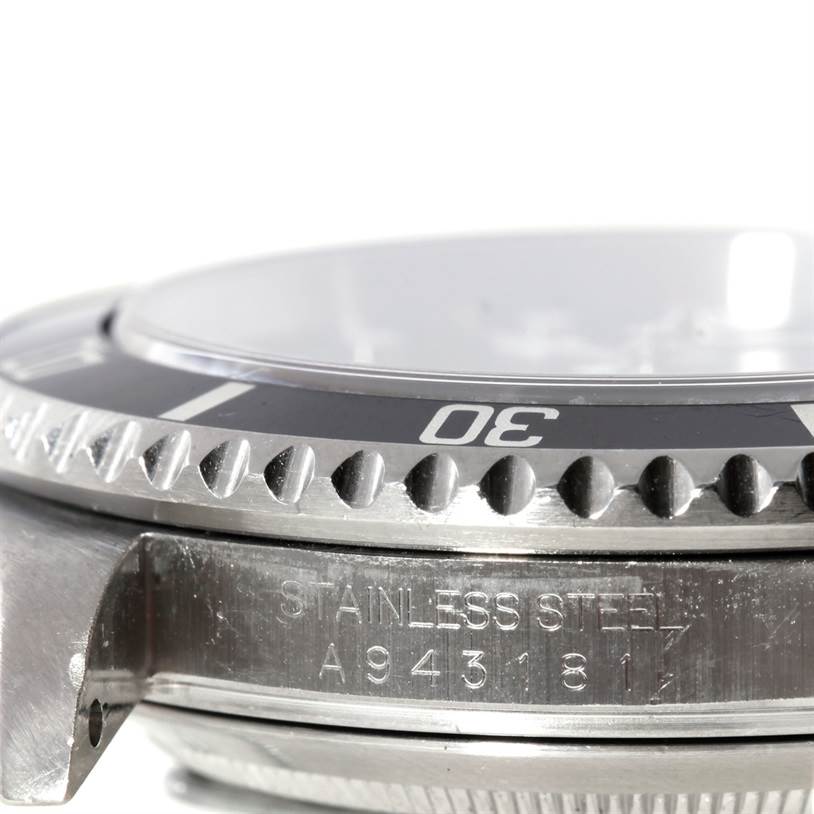 This image shows a close-up side angle of the Rolex Submariner 16610 Men
s Stainless Steel Black Dial 16610 Men
s Stainless Steel Black Dial, focusing on the bezel and case engraved with "STAINLESS STEEL A9431817".