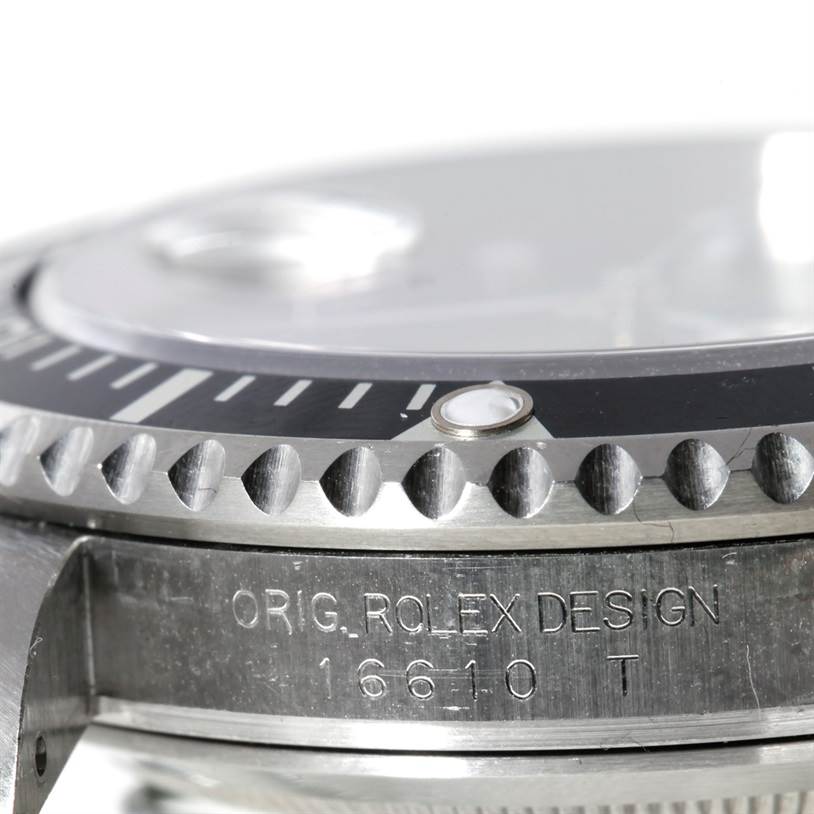 This close-up angle of the Rolex Submariner 16610 Men
s Stainless Steel Black Dial 16610 Men
s Stainless Steel Black Dial shows part of the bezel, dial, and engraved case side.