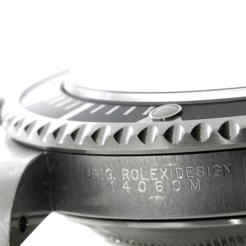 The image shows a close-up of the bezel and casing side of a Rolex Submariner 14060 Men
s Stainless Steel Black Dial 14060 Men
s Stainless Steel Black Dial, highlighting its "ORIG. ROLEX DESIGN" engraving.