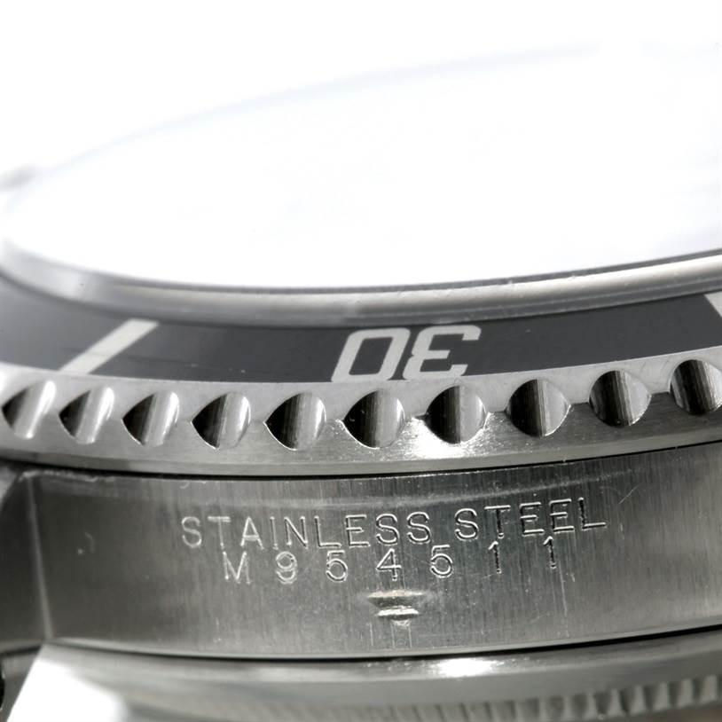 This image shows a close-up of the bezel and part of the case back of a Rolex Submariner 14060 Men
s Stainless Steel Black Dial 14060 Men
s Stainless Steel Black Dial watch.
