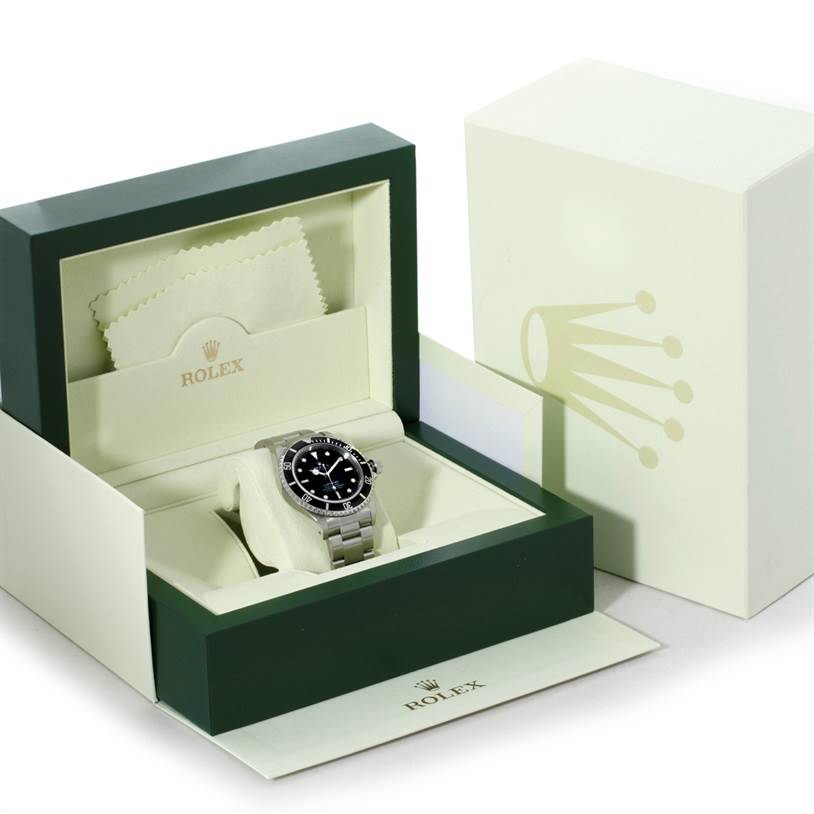 The image shows a Rolex Submariner 14060 Men
s Stainless Steel Black Dial 14060 Men
s Stainless Steel Black Dial watch inside its open box, with a cleaning cloth on the inner lid.