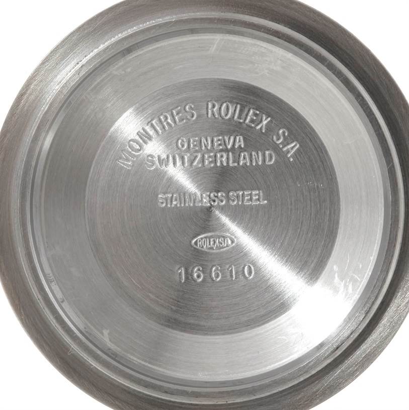 This image displays the back cover of a Rolex Submariner 16613 Men's Steel and Gold (two tone) Blue Dial 16613 Men's Steel and Gold (two tone) Blue Dial, model number 16610, showing "Montres Rolex S.A." and "Geneva Switzerland" engravings.