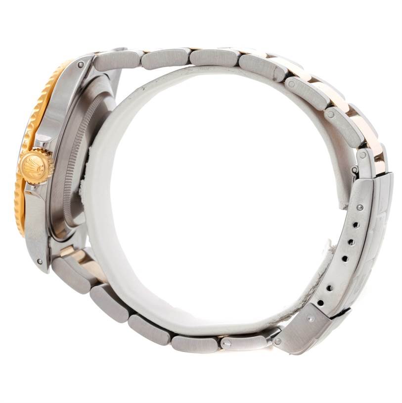 The image shows a side view of a Rolex Submariner 16613 Men's Steel and Gold (two tone) Blue Dial 16613 Men's Steel and Gold (two tone) Blue Dial watch, highlighting the case, crown, and bracelet.