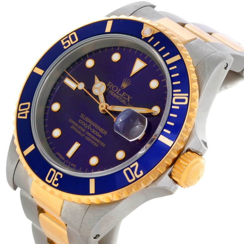 The image shows a close-up of the Rolex Submariner 16613 Men's Steel and Gold (two tone) Blue Dial 16613 Men's Steel and Gold (two tone) Blue Dial's face and part of its bracelet at a slight angle, highlighting the bezel and crown.