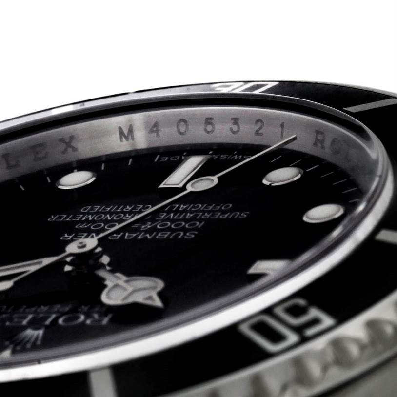 The image shows a close-up of the Rolex Submariner 14060 Men
s Stainless Steel Black Dial 14060 Men
s Stainless Steel Black Dial watch, focusing on the dial, hands, and part of the bezel.