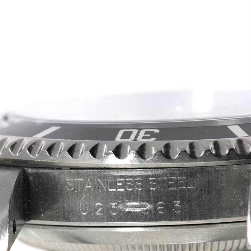 This image shows a close-up of the bezel and engraved side of a Rolex Submariner 14060 Men
s Stainless Steel Black Dial 14060 Men
s Stainless Steel Black Dial watch in stainless steel.