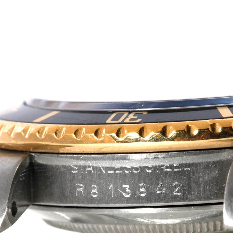 This close-up image shows the stainless steel case, bezel, and serial number of the Rolex Submariner 16803 Men's Steel and Gold (two tone) Black Dial 16803 Men's Steel and Gold (two tone) Black Dial watch.