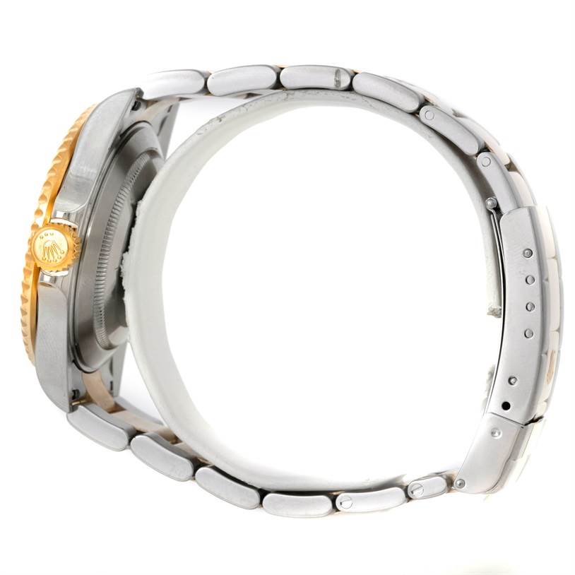 The image shows a Rolex Submariner 16613 Men's Steel and Gold (two tone) Black Dial 16613 Men's Steel and Gold (two tone) Black Dial watch from the side, focusing on the crown and part of the bracelet.