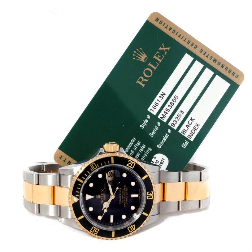 The Rolex Submariner 16613 Men's Steel and Gold (two tone) Black Dial 16613 Men's Steel and Gold (two tone) Black Dial watch is shown from a front angle along with its authentication card.