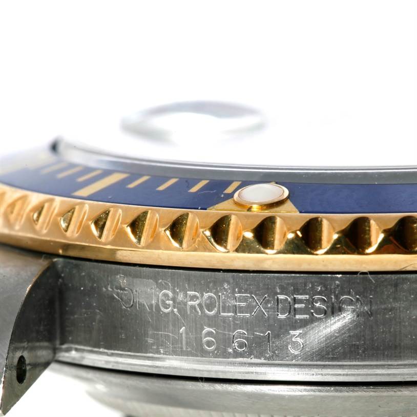 This close-up angle shows the bezel, case, and part of the serial number of a Rolex Submariner 16613 Men's Steel and Gold (two tone) Grey Dial 16613 Men's Steel and Gold (two tone) Grey Dial watch.