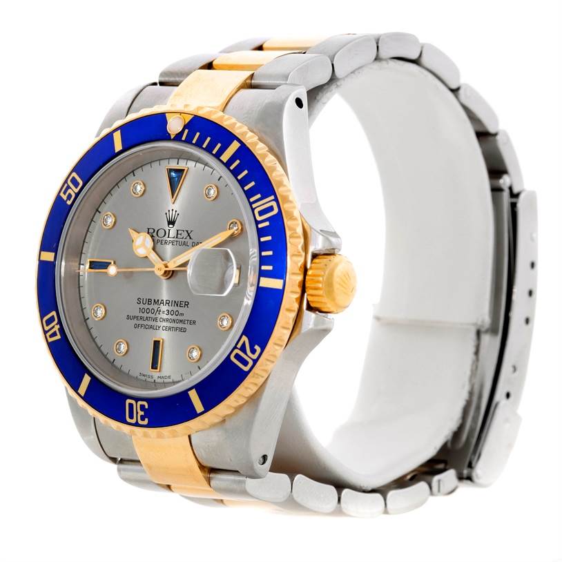 The image displays a side angle of a Rolex Submariner 16613 Men's Steel and Gold (two tone) Grey Dial 16613 Men's Steel and Gold (two tone) Grey Dial watch, showcasing its bezel, dial, crown, and bracelet.