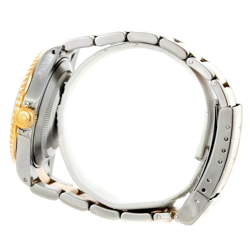 The image displays a side view of a Rolex Submariner 16613 Men's Steel and Gold (two tone) Grey Dial 16613 Men's Steel and Gold (two tone) Grey Dial watch, showcasing its crown, bezel, and metal bracelet.