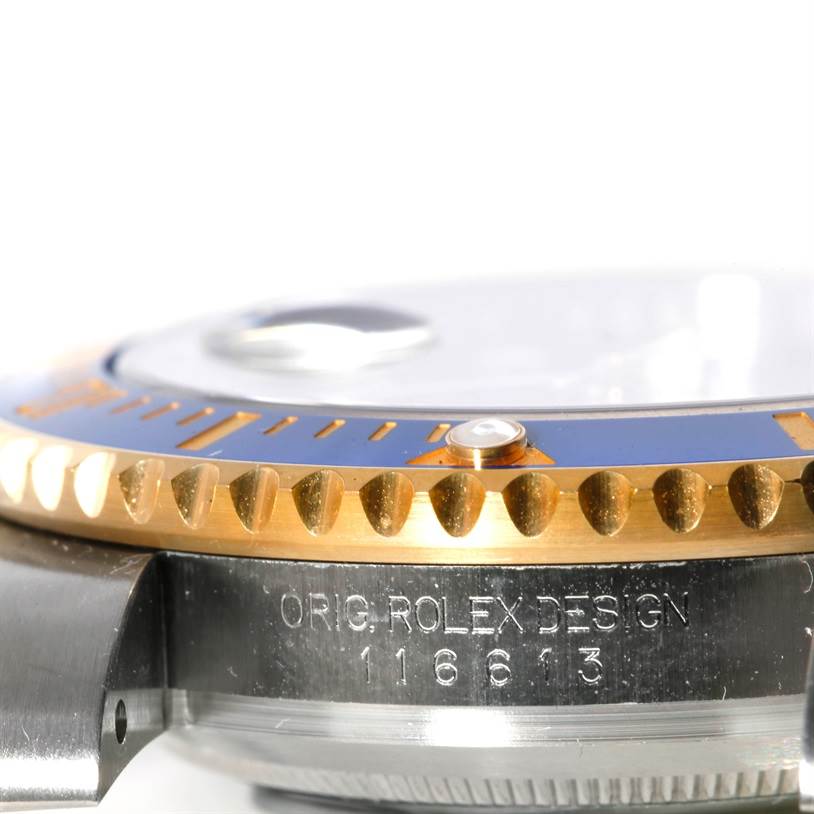 This close-up angle shows the side of the Rolex Submariner 116613 Men's Steel and Gold (two tone) Blue Dial 116613 Men's Steel and Gold (two tone) Blue Dial's bezel and case with the model number engraved.