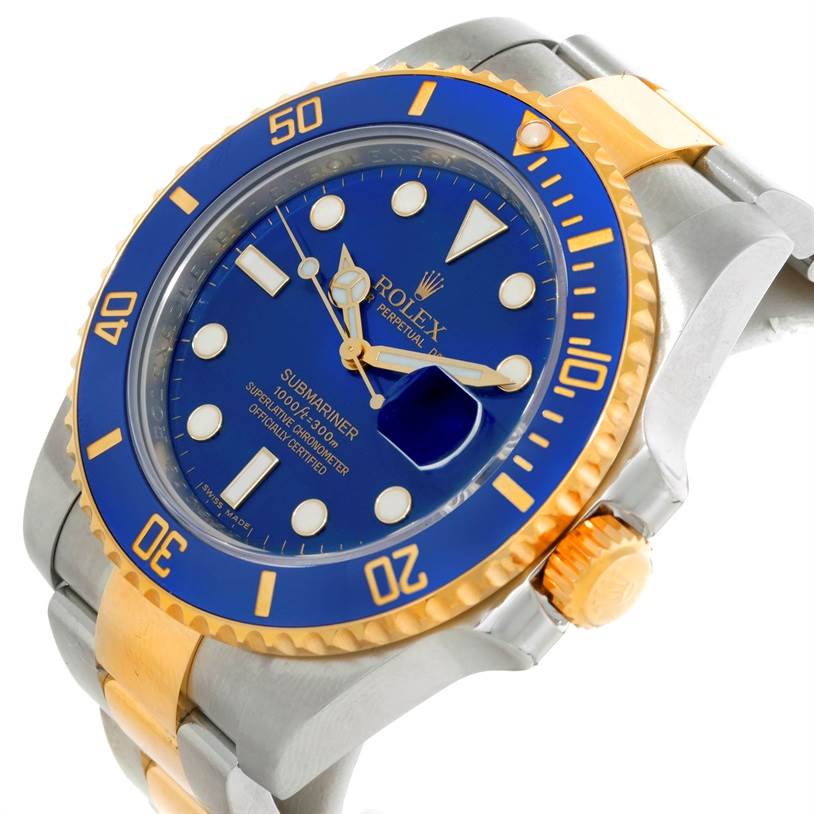The Rolex Submariner 116613 Men's Steel and Gold (two tone) Blue Dial 116613 Men's Steel and Gold (two tone) Blue Dial watch is shown at a tilted angle, highlighting its blue face, gold accents, and two-tone metal bracelet.