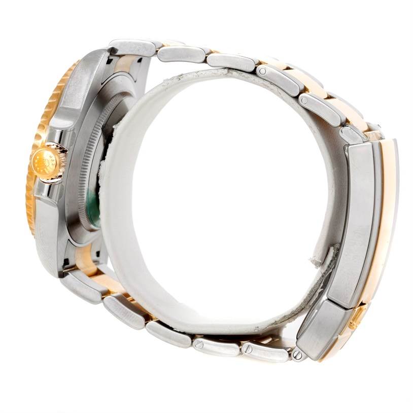 The image shows a side view of a Rolex Submariner 116613 Men's Steel and Gold (two tone) Blue Dial 116613 Men's Steel and Gold (two tone) Blue Dial model, highlighting the bracelet, crown, and case.