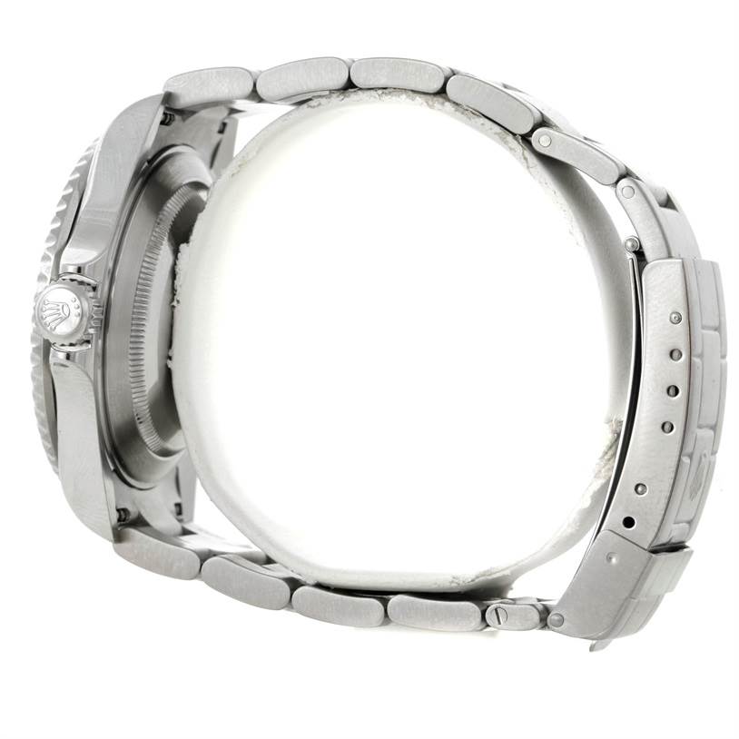 Side view of a Rolex Submariner 16610 Men
s Stainless Steel Black Dial 16610 Men
s Stainless Steel Black Dial, showing the bracelet, the case, and the screw-down crown.